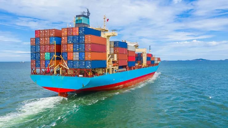 Refrigerated shipping containers stacked aboard a vessel